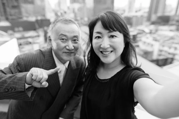 Mature homme d'affaires asiatique et mature femme asiatique explorer la ville ensemble — Photo
