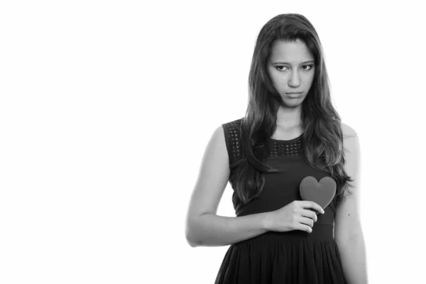 Studio shot van mooie jongedame rood hart houden terwijl het zoeken van triest — Stockfoto