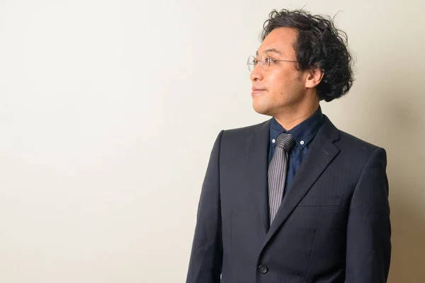 Vista de perfil del empresario japonés en traje pensando —  Fotos de Stock