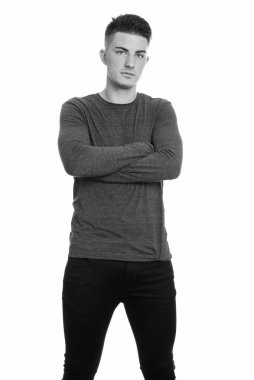 Siyah beyaz arka planda izole edilmiş yakışıklı bir gencin stüdyo fotoğrafı.