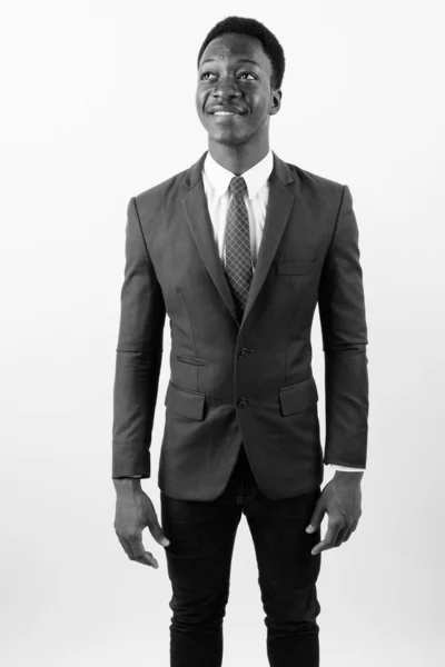 Young handsome African businessman wearing suit against white background — Stock Photo, Image