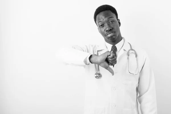 Young handsome African man doctor against white background — Stock Photo, Image