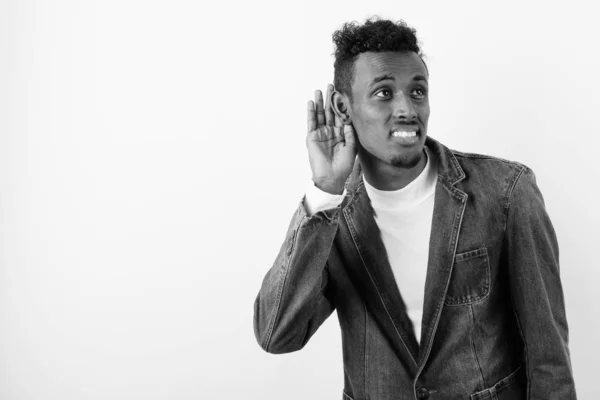 Young bearded African man wearing denim jacket against white background — Stock Photo, Image