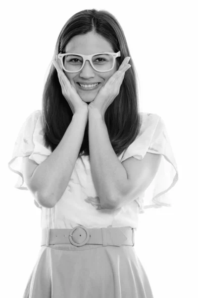 Studio shot van gelukkige jonge mooie vrouw glimlachend en aanraken van beide wangen tijdens het dragen van bril — Stockfoto