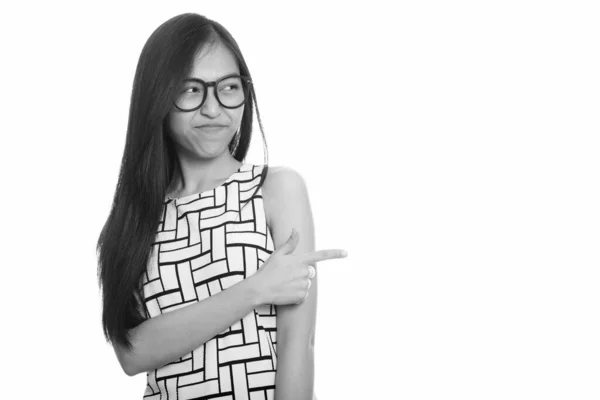 Young Asian teenage nerd girl pointing finger while looking disgusted — Stock Photo, Image