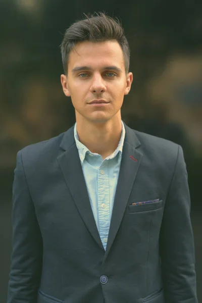 Portrait of young handsome businessman exploring the city — Stock Photo, Image