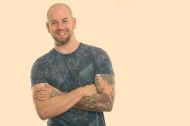 Beyaz arka planda izole edilmiş genç kaslı kel adamın stüdyo fotoğrafı.