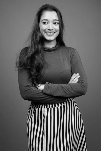 Young beautiful Indian woman against gray background — Stock Photo, Image