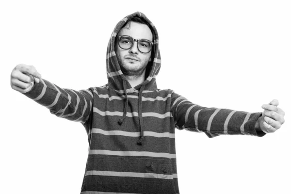 Studio shot of young man wearing hoodie while pointing both fingers at himself — Stock Photo, Image