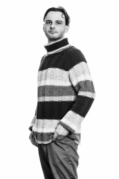 Studio shot of young man standing in black and white — Stock Photo, Image