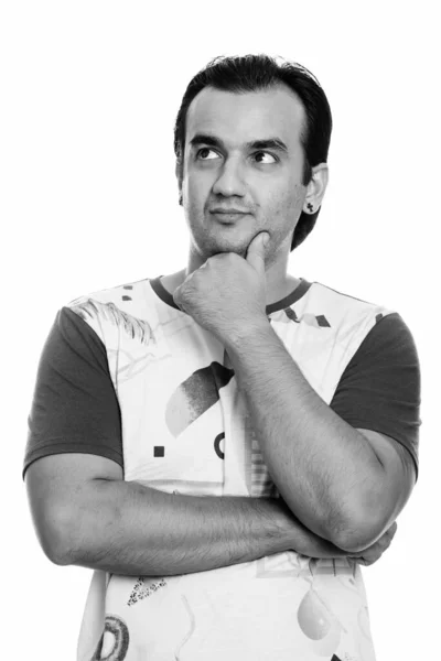 Studio shot of Persian man thinking while looking up — Stock Photo, Image