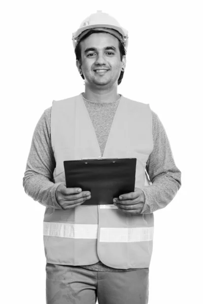 Happy Persian man construction worker smiling while holding clipboard — Stock Photo, Image
