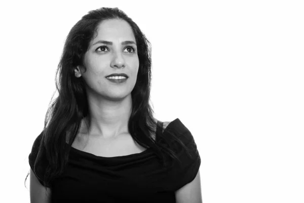 Studio shot of happy Persian woman smiling while thinking — Stock Photo, Image