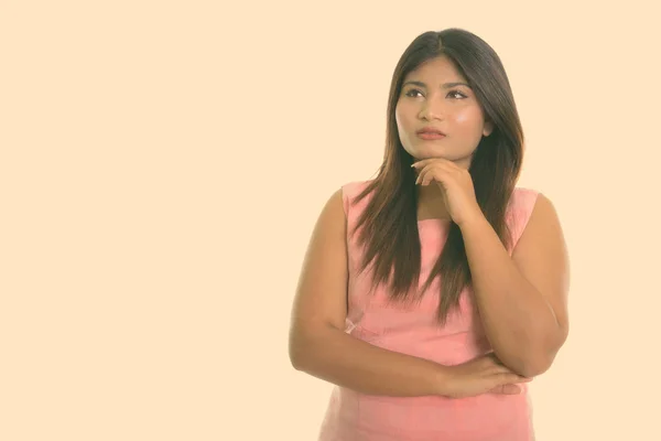 Studio shot of young fat Persian teenage girl thinking isolated against white background — Stock Photo, Image