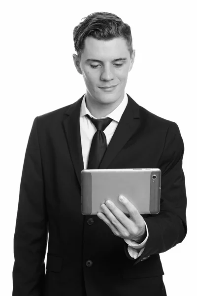 Young handsome businessman with curly hair wearing suit Stock Photo