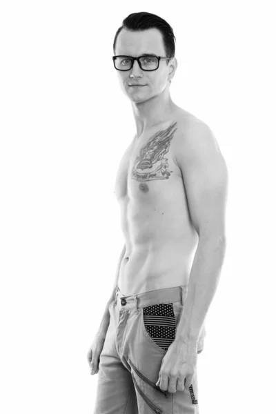 Studio shot van de knappe jongeman permanent shirtless terwijl het dragen van bril — Stockfoto
