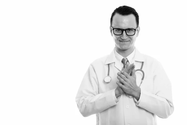 Studio shot of young handsome man doctor rubbing hands together — Stock Photo, Image