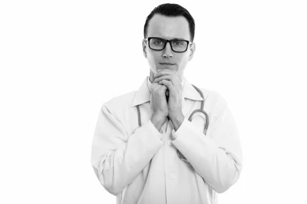 Studio shot of young worried man doctor looking at camera — Stock Photo, Image