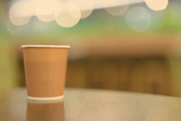 Hot Coffee In Paper Cup Placed On Wooden Table Inside The Coffee Shop — Stok Foto