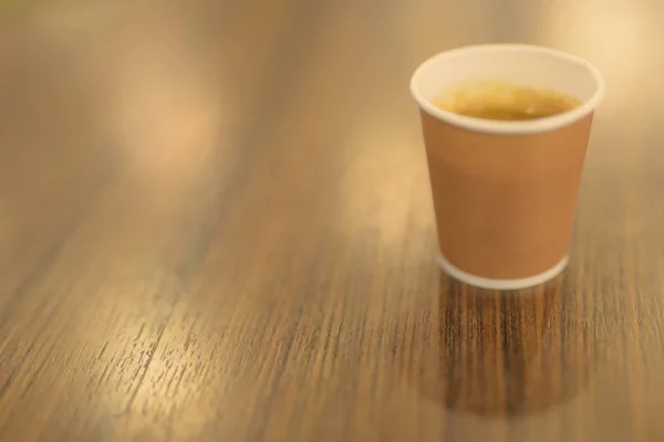 Hot Coffee In Paper Cup Placed On Wooden Table Inside The Coffee Shop — Stok Foto