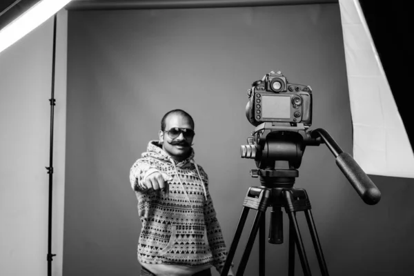 Indian man with mustache vlogging against gray background — 스톡 사진