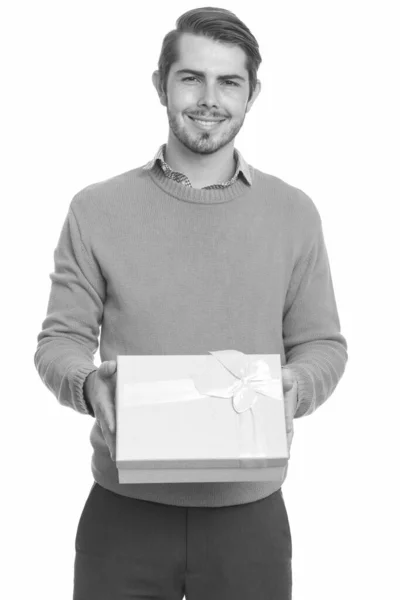 Молодой счастливый кавказский мужчина дарит подарочную коробку на день святого Валентина — стоковое фото