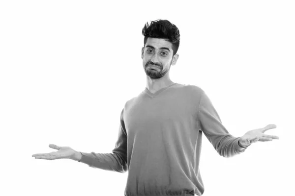 Studio shot of young Persian man looking confused — Stock Photo, Image