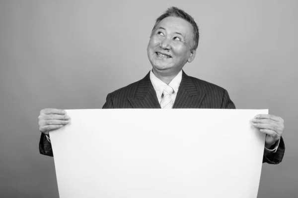Studio Shot Mature Asian Businessman Holding White Board Gray Background — Fotografia de Stock