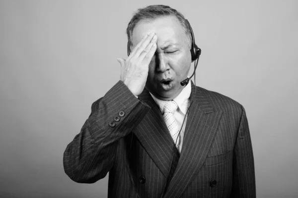 Studio Shot Mature Asian Businessman Call Center Representative Gray Background —  Fotos de Stock