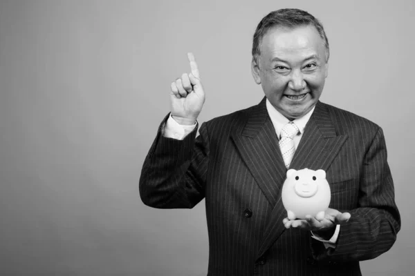 Studio Shot Mature Asian Businessman Holding Piggy Bank Gray Background — Stock Photo, Image