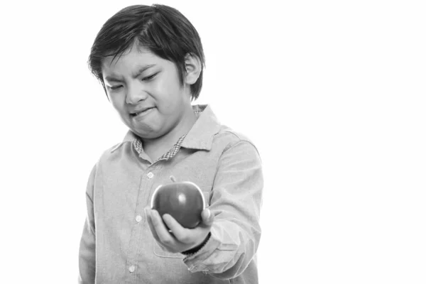 Studio záběr roztomilé japonské chlapce drží červené jablko a znechuceným — Stock fotografie