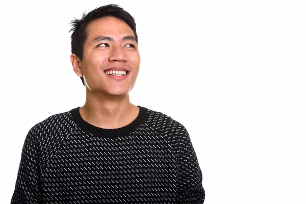 Estudio disparo de joven feliz asiático hombre sonriendo mientras pensaba —  Fotos de Stock