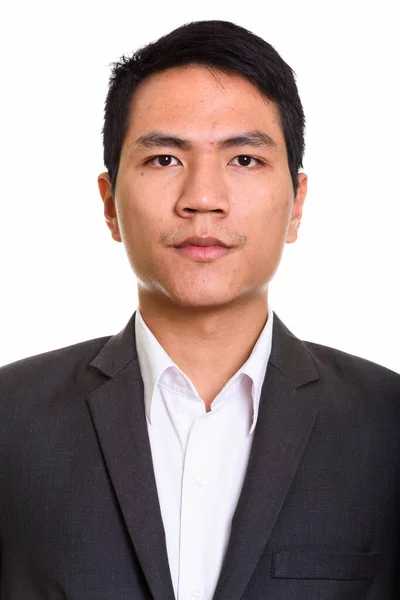 Gezicht van jonge Aziatische zakenman in pak — Stockfoto
