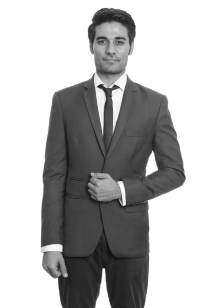 黒と白の白い背景を背景に隔離された訴訟で若いハンサムなペルシャのビジネスマンのスタジオショット — ストック写真
