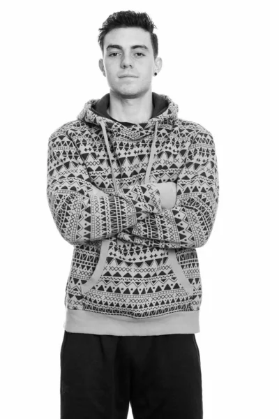 Studio shot of young man standing with arms crossed — Stock Photo, Image