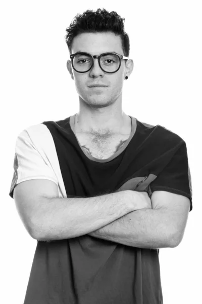 Studio shot of young man with arms crossed — Stock Photo, Image