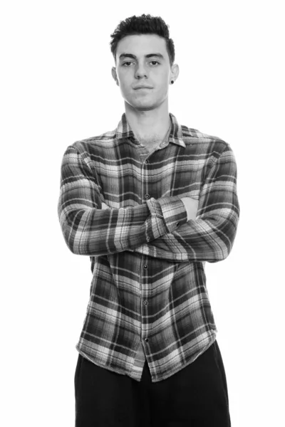 Studio shot of young man standing with arms crossed — Stock Photo, Image