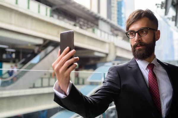 Young handsome bearded Persian businessman relaxing around the city — Stock Photo, Image