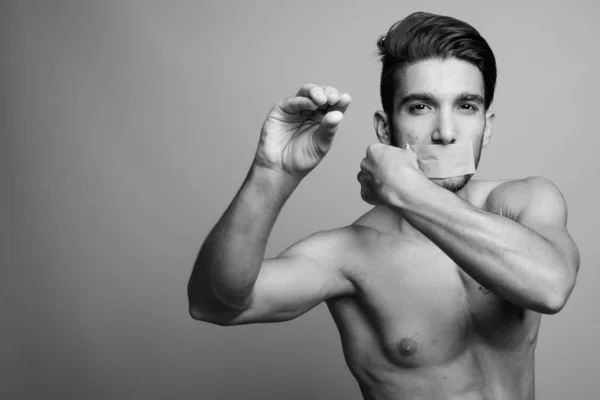 Young handsome Persian man shirtless against gray background — Stock Image Young handsome Persian man shirtless against gray background Royalty Free Stock Images