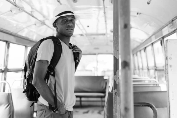 Young African tourist man standing while riding the bus — Stock Photo, Image