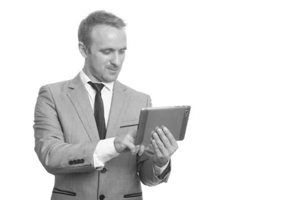 Portrait of handsome businessman in suit using digital tablet — Stock Photo, Image