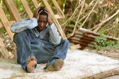 Portrait of young homeless African man in the streets outdoors