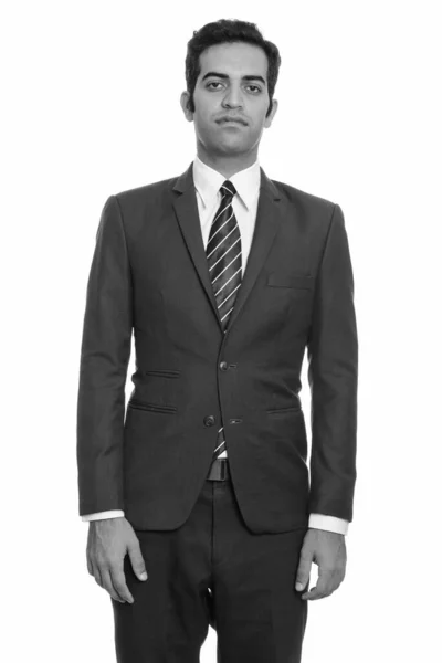 黒と白の白の背景を背景に隔離された訴訟で若いペルシャのビジネスマンのスタジオショット — ストック写真