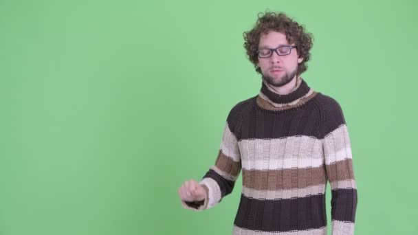 Stressed young bearded man touching something and giving thumbs down — Stock Video