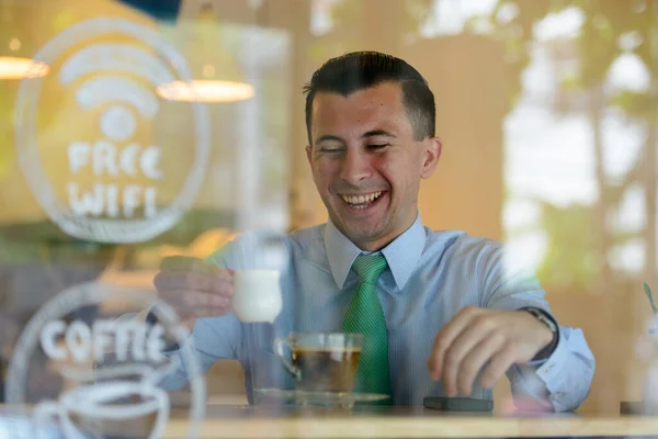 Portrait of young handsome businessman inside the coffee shop