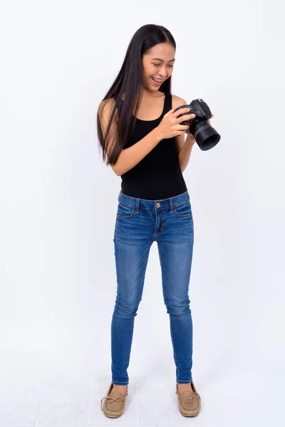 Plan complet du corps de heureuse jeune femme asiatique à l'aide de la caméra — Photo