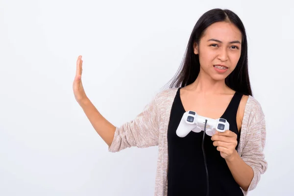 Portrait of stressed young Asian woman playing games — Stock Photo, Image