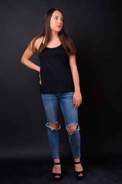 Studio shot of young multi ethnic beautiful woman against black background