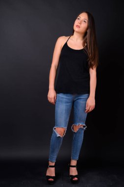 Studio shot of young multi ethnic beautiful woman against black background