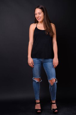 Studio shot of young multi ethnic beautiful woman against black background